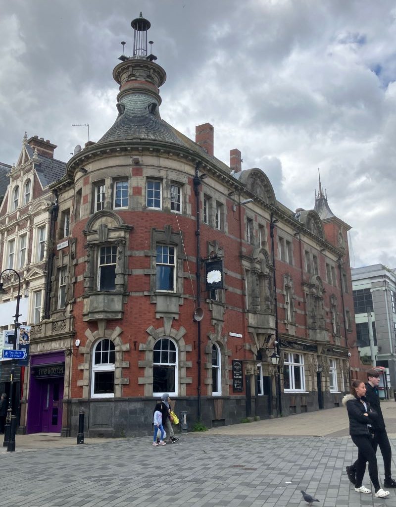 Image of a Victorian corner city centre building with a round tower