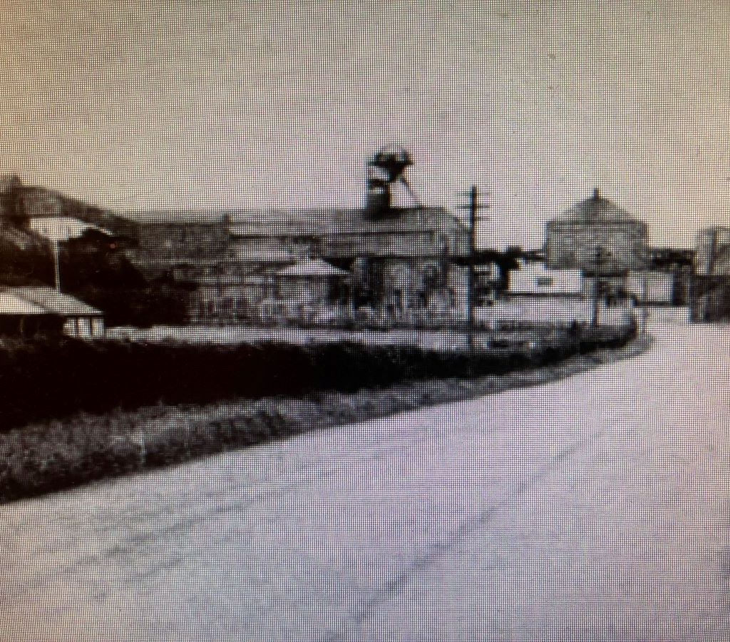 An image of Harraton Cricket Welfare Ground as it was, with the pavilion to the left of the photo and the colliery in the background